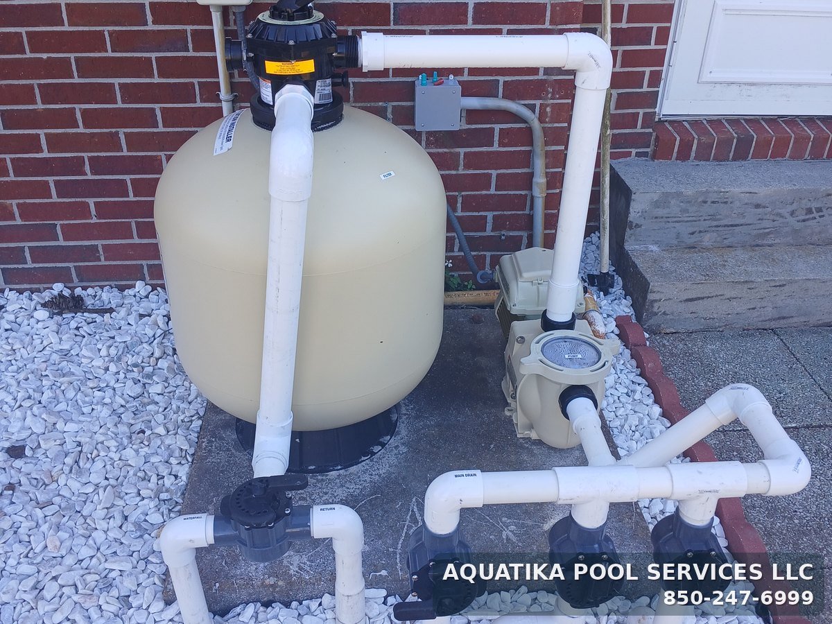 Pool equipment pad with sand filter, multiport valve, pump and valve manifold plumbed by Aquatika Pool Services
