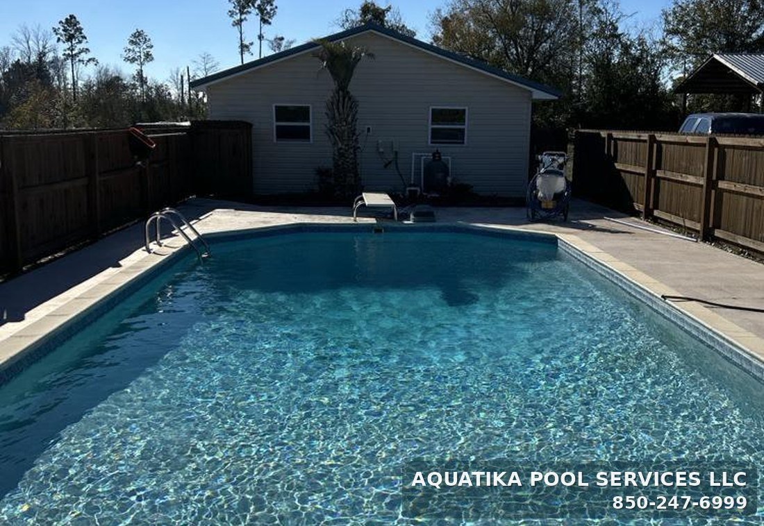 Clear inground backyard pool serviced weekly in Panama City, Florida